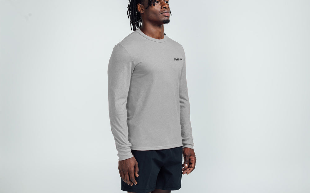 Man wearing Heather Gray/Black Long-Sleeved Tri-Blend Crew