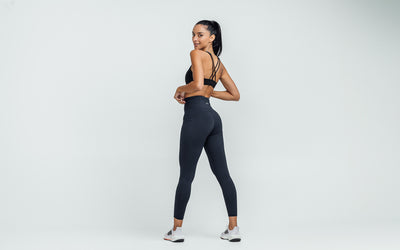 Back view of model wearing the REP Hera Tights in Navy.