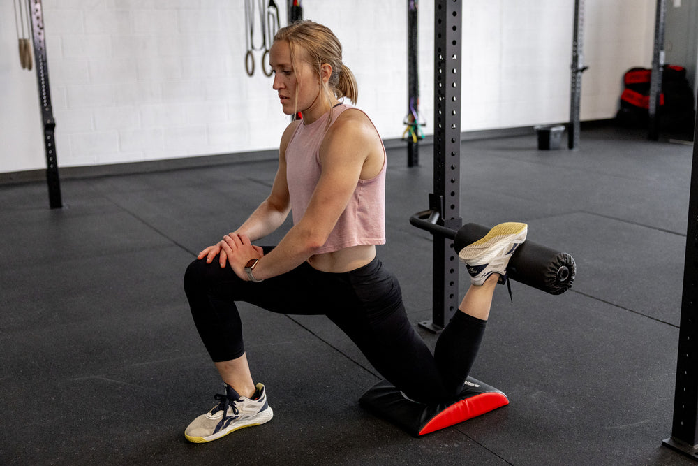 Rig with Leg Roller Attachment and an athlete stretching