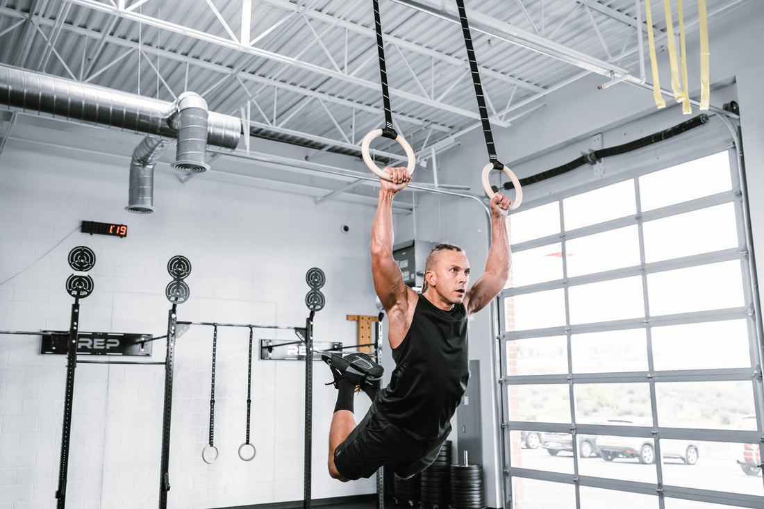 Action shot: An athlete is swinging themselves on the REP Competition Gymnastic Straps and Wood Rings