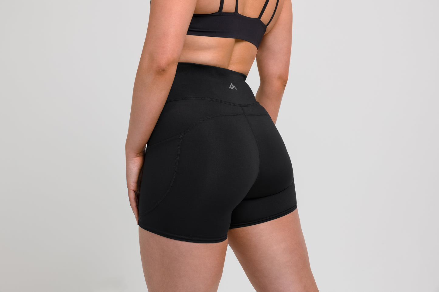 Women's Shorts - Athlete wearing the Black REP Women’s Forma Shorts on a gray background.