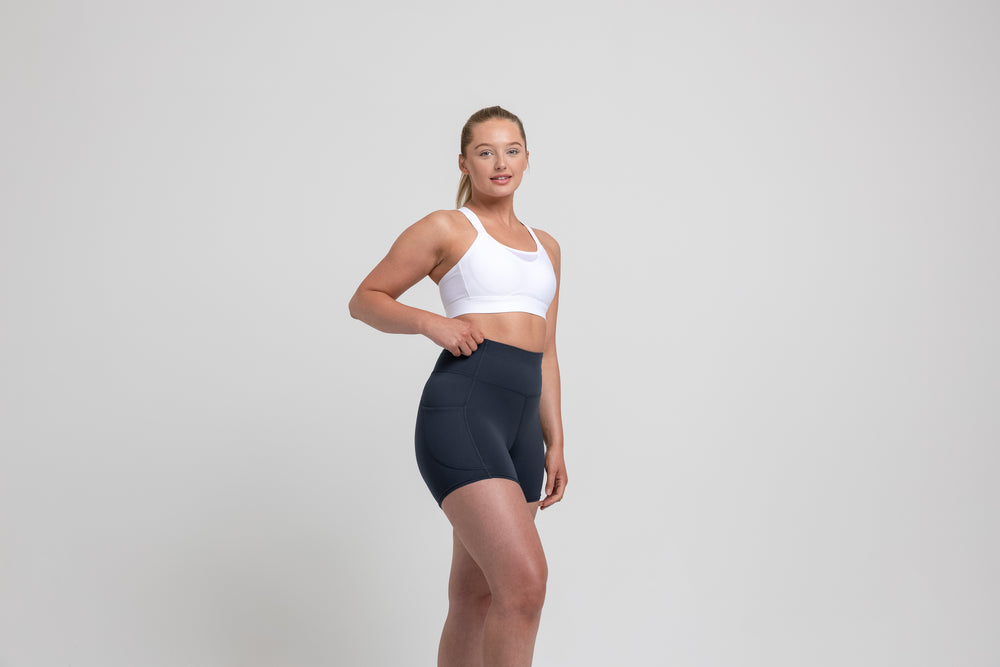 Athlete wearing the navy REP Women’s Forma Shorts.