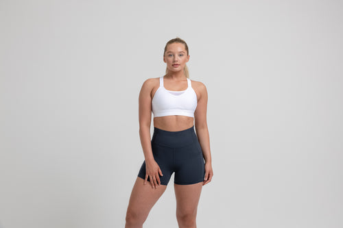 Athlete wearing the navy REP Women’s Forma Shorts.