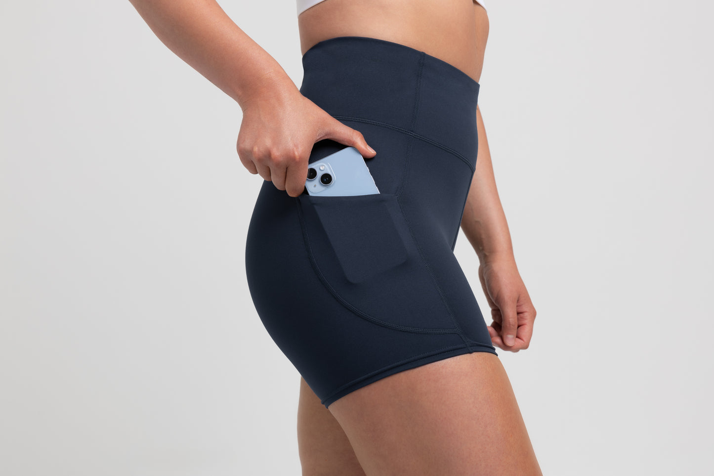 Athlete wearing the Navy REP Women’s Forma Shorts.