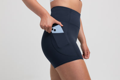 Athlete wearing the Navy REP Women’s Forma Shorts.