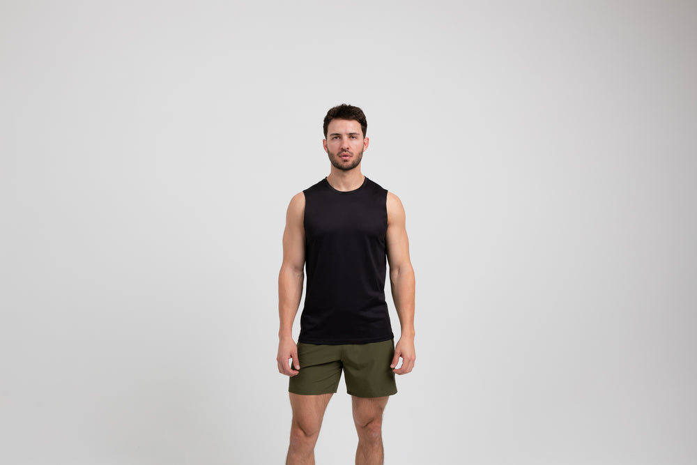 Athlete wearing a black REP Men's Solis Muscle Tee.