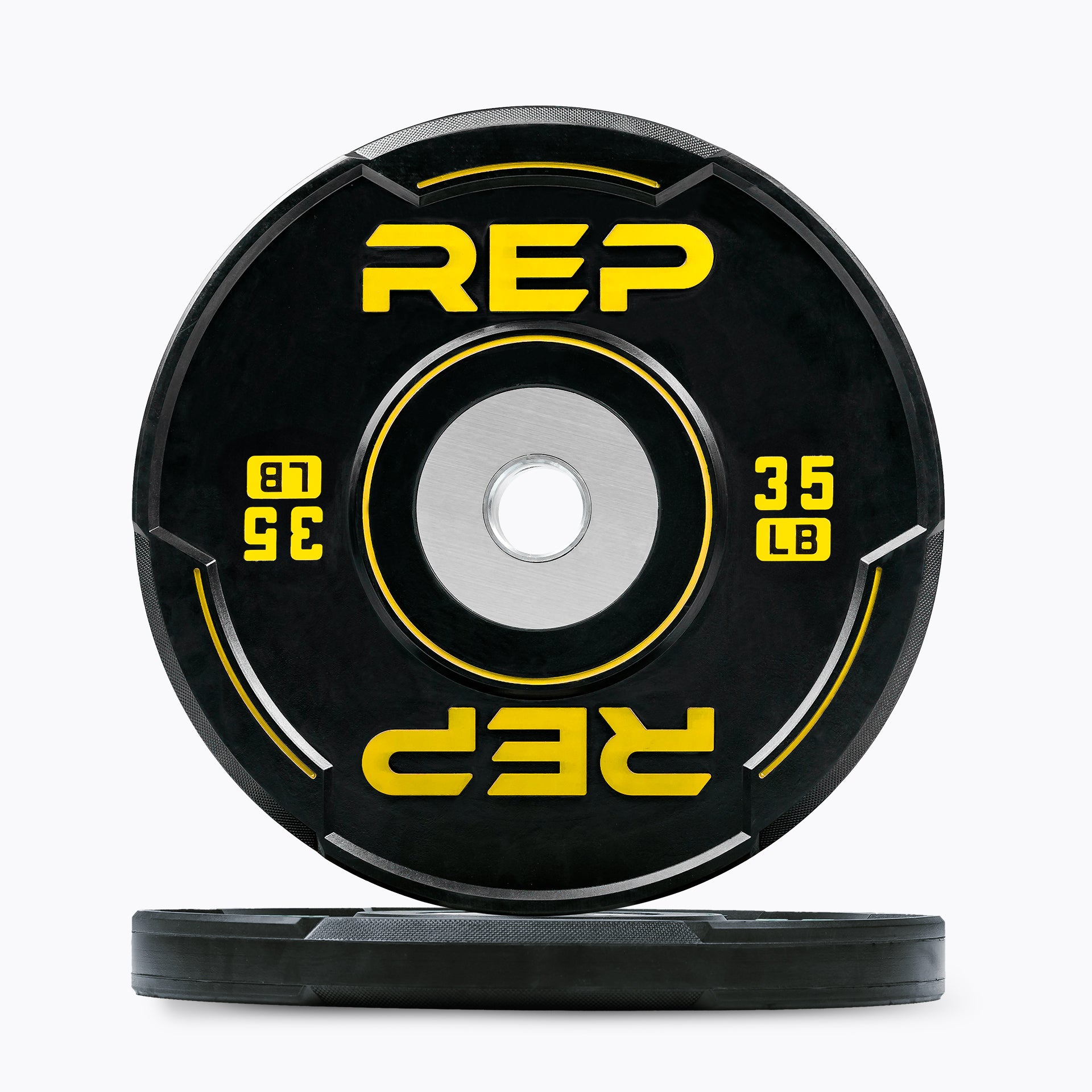Studio-shot: Front and side profile of a yellow 35 lb REP Sport Bumper Plate 2.0 on a white background