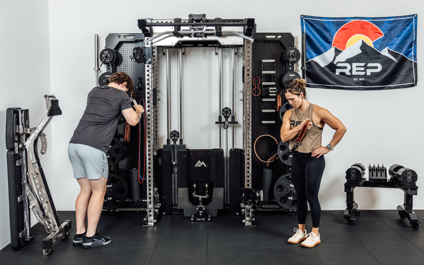 Two athletes performing cable exercises at the same time on the Wall-Mounted Ares™ 2.0