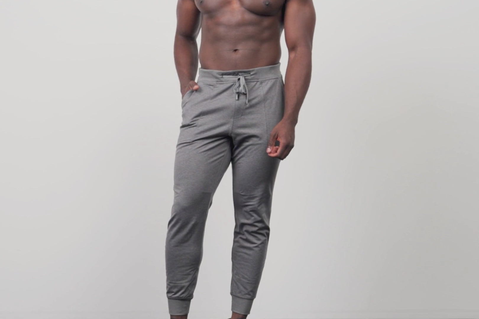 A video of an athlete adjusting the waist of the grey Men's Apollo Joggers