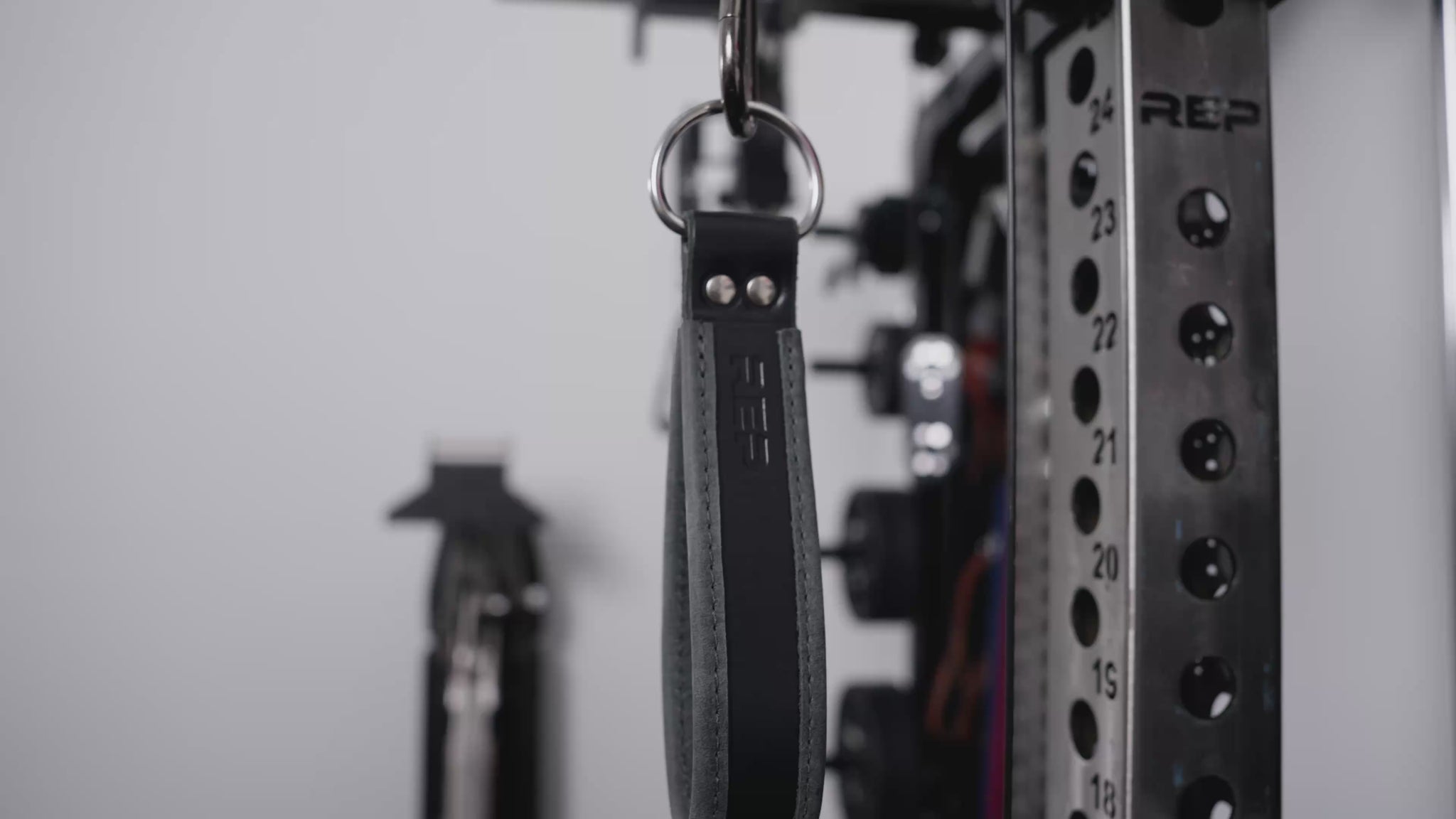 Athletes working out on an Ares 2.0 with the REP® USA Leather Single Handle Cable Attachments