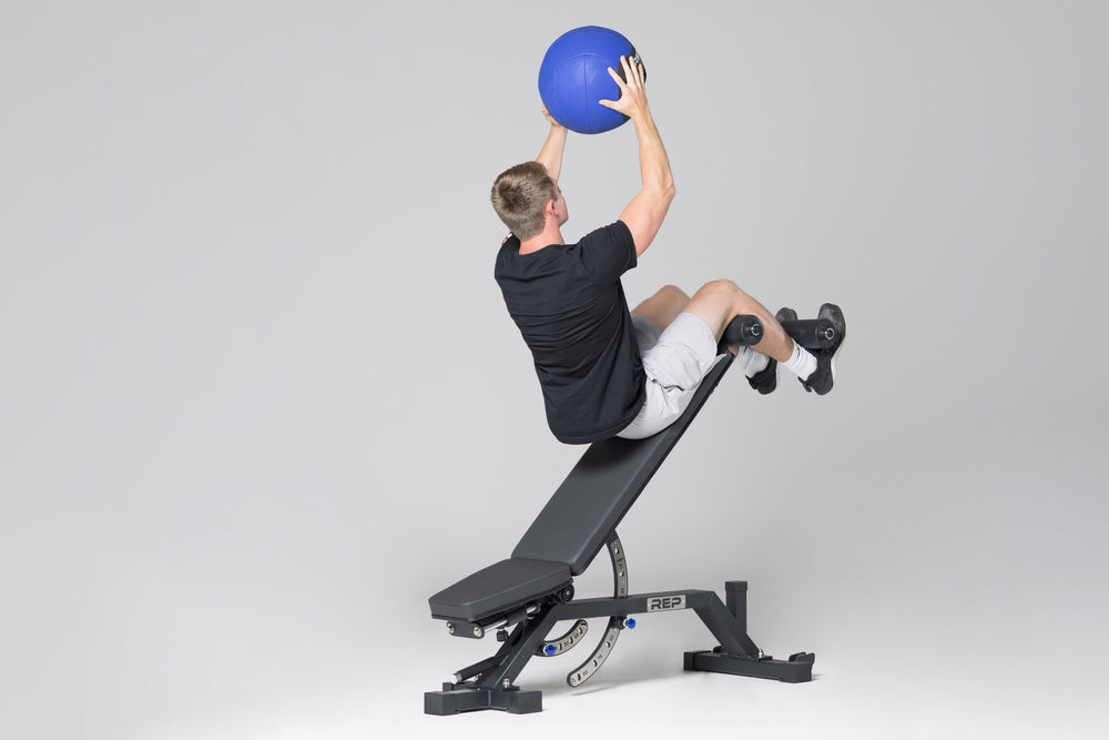 Decline sit-ups using leg roller attachment