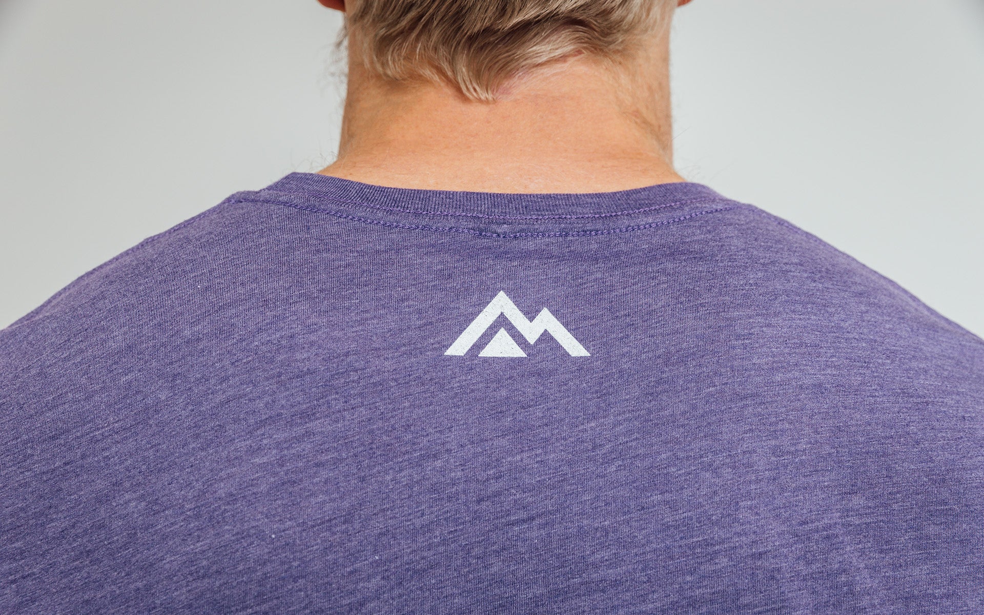 REP mountain logo on back of purple daily driver shirt