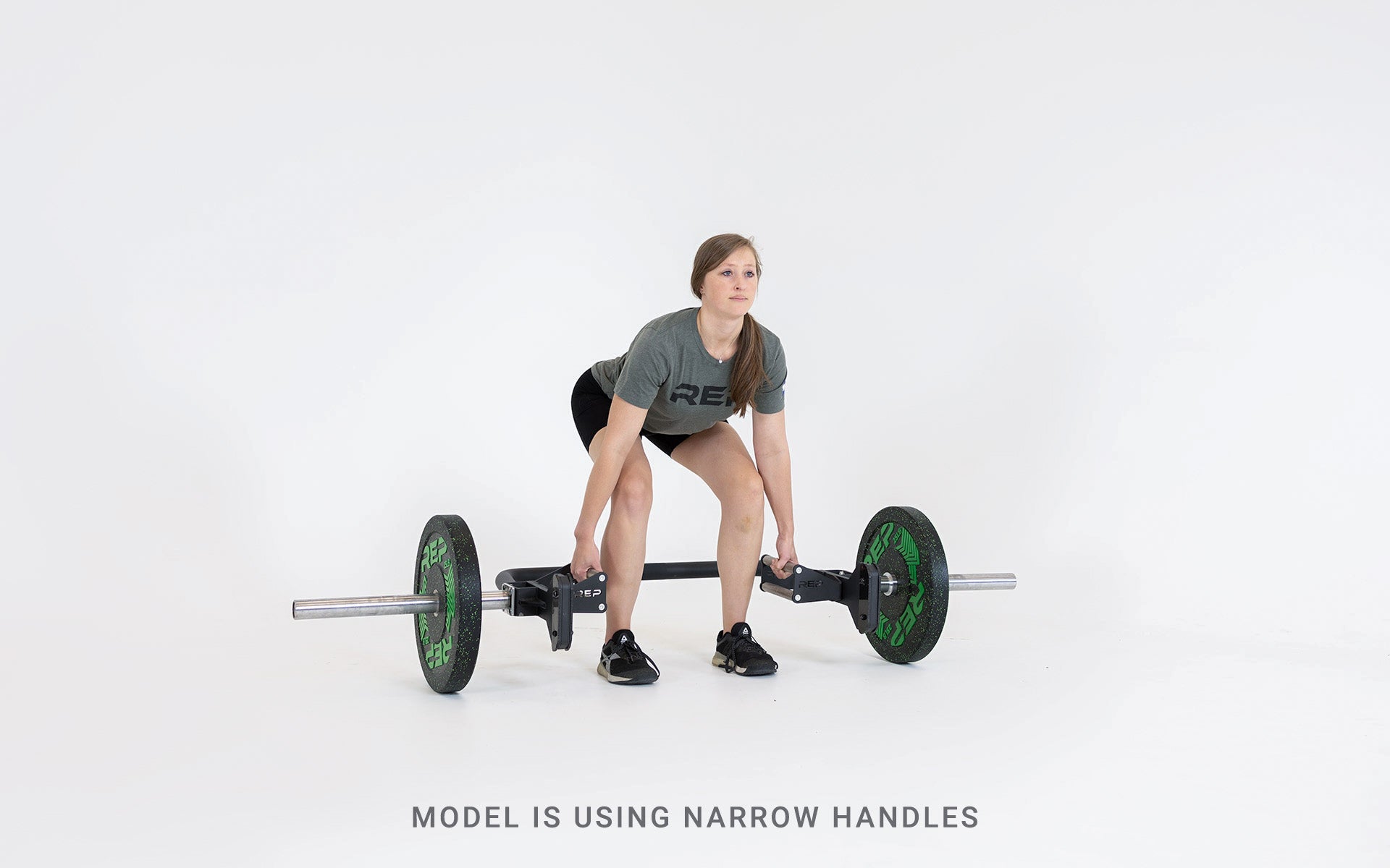 Lifter set up for a deadlift using the open trap bar with narrow handles.