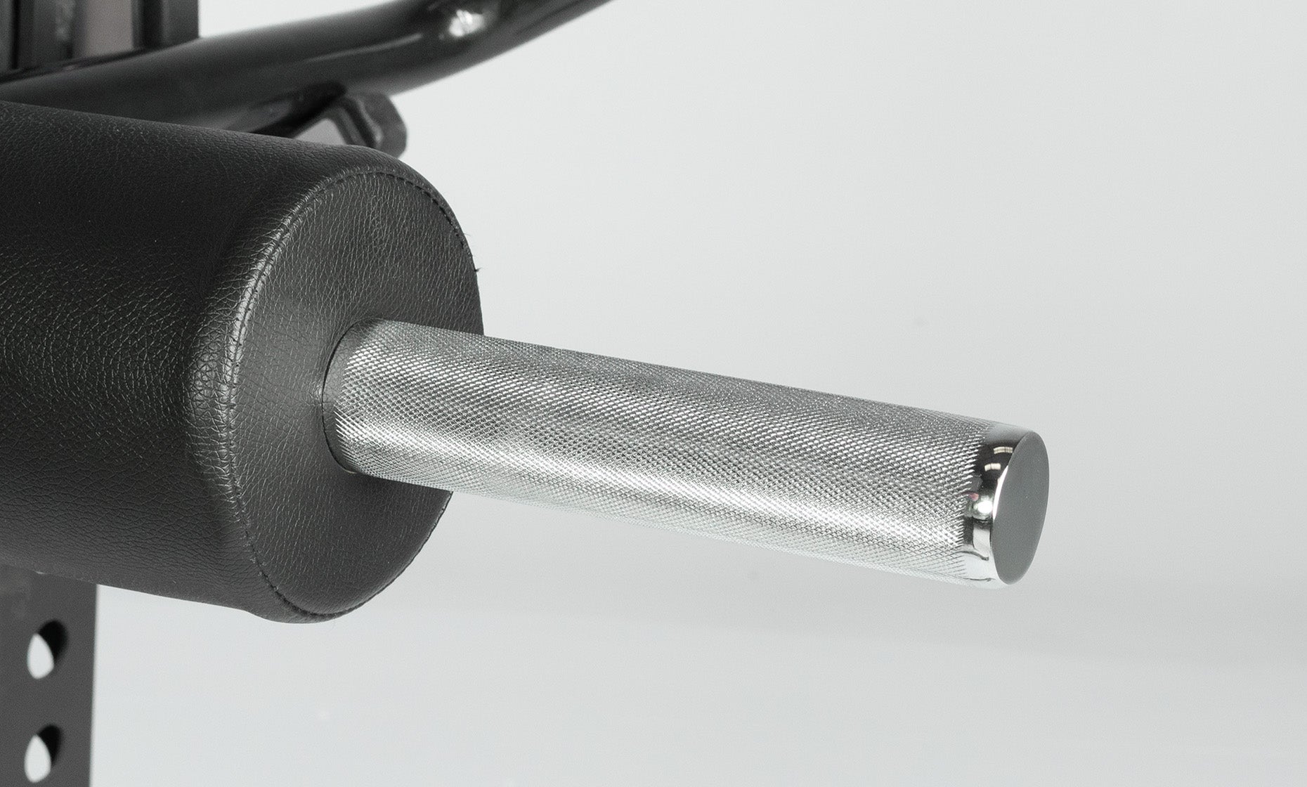 Close-up of a knurled safety squat bar handle.