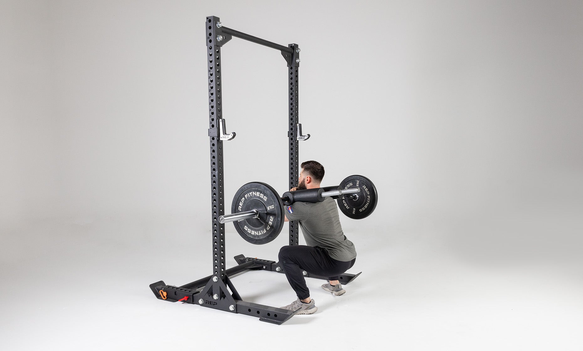 Lifter using a loaded Safety Squat Bar to perform a front squat outside of a REP Yoke.