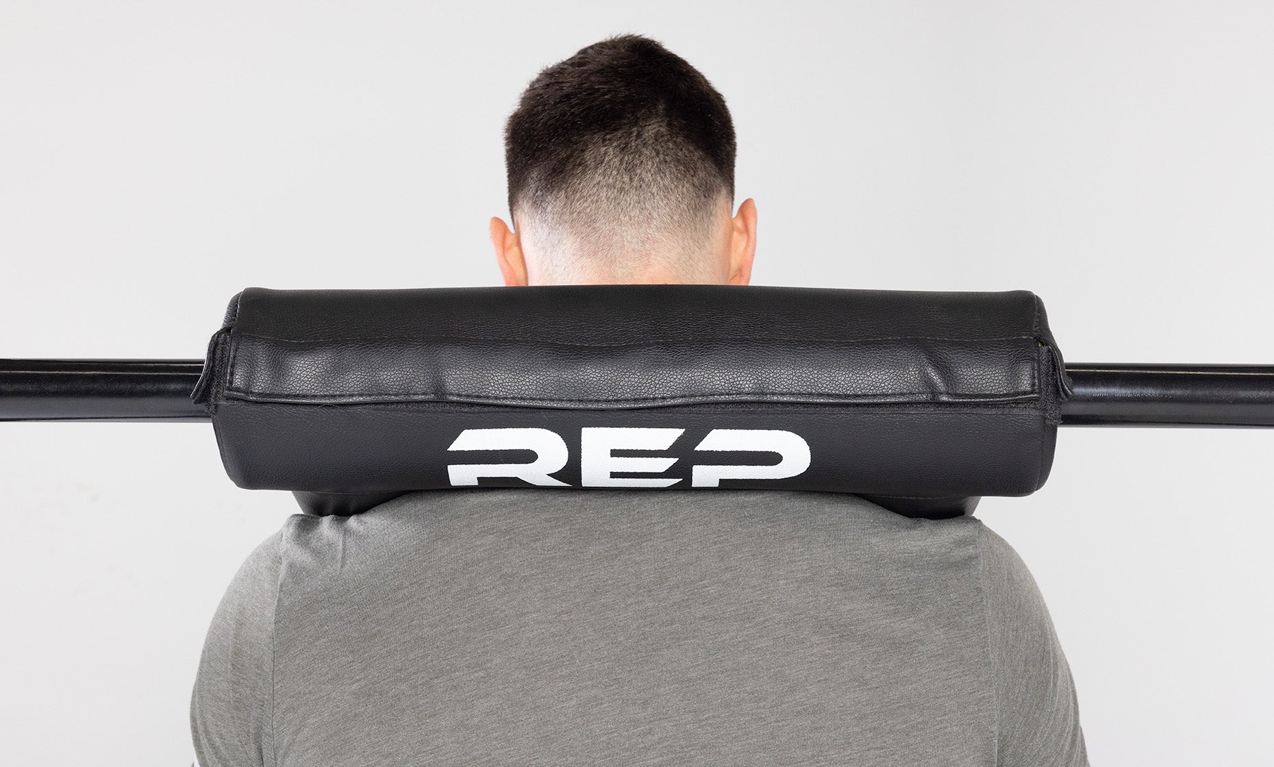 Back view of Safety Squat Bar pad with REP logo while in use.