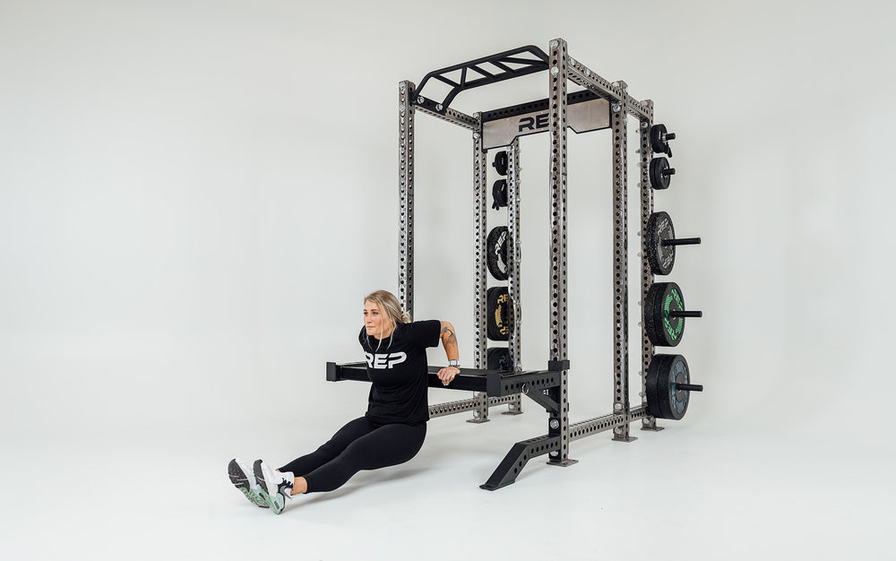 Utility Seat Installed on Spotter Arms on Power Rack Being Used For Tricep Dips