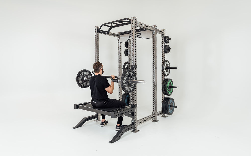 Utility Seat Installed on Spotter Arms on Power Rack Being Used For A Seated Press