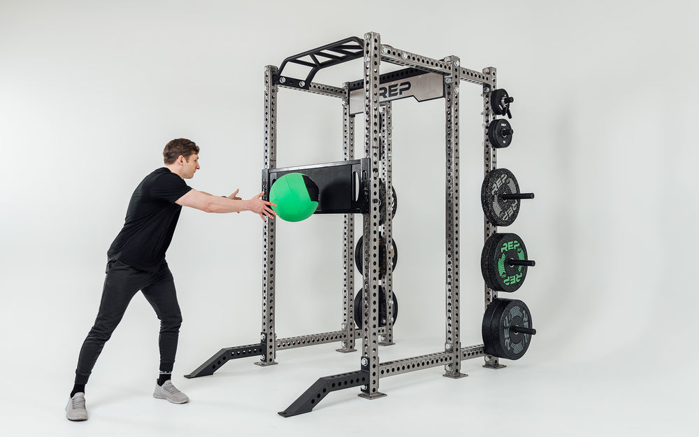 Utility Seat Installed on Uprights on Power Rack Being Used for Ball Tosses