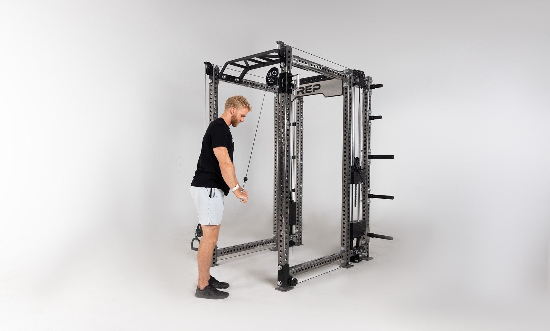 Athena Selectorized Side-Mount Functional Trainer Dual Side Shown on Clear Coat PR-5000 Power Rack Being Used For Tricep Pushdowns