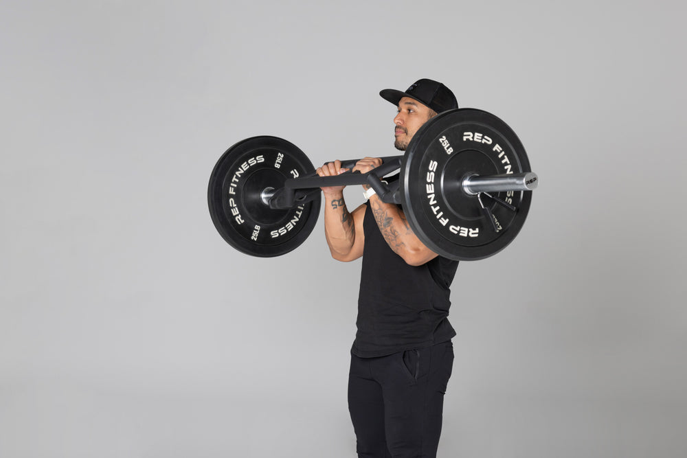 Lifter using loaded Cambered Swiss Bar for bicep curls.