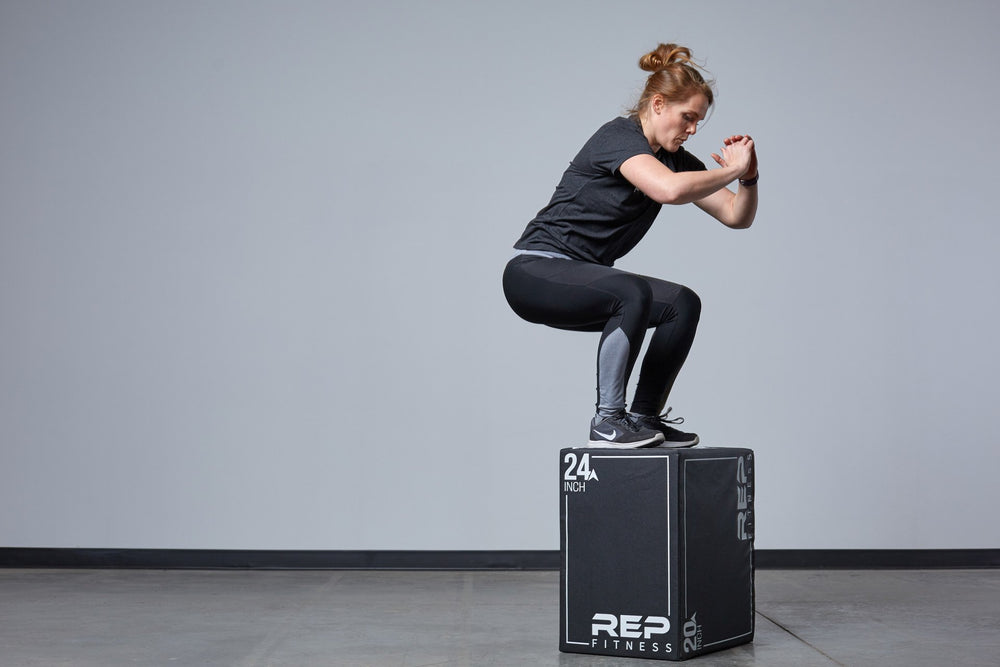 Individual performing box jumps on the Medium REP 3-in-1 Soft Plyo Box.