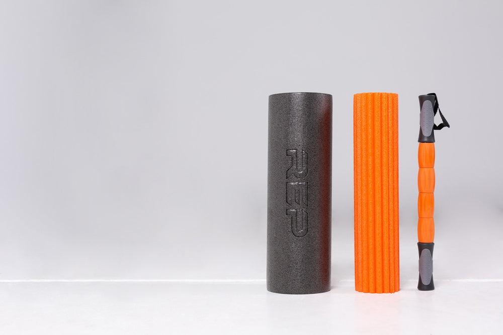 All three rolling utensils standing vertically side by side: outer foam roller, ridged foam roller, and mobility stick.