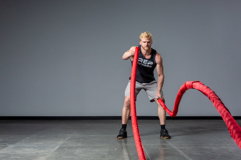 Exercising with red Battle Ropes