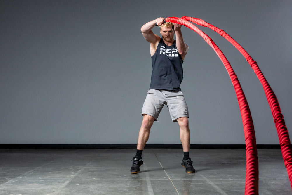 Exercising with red Battle Ropes