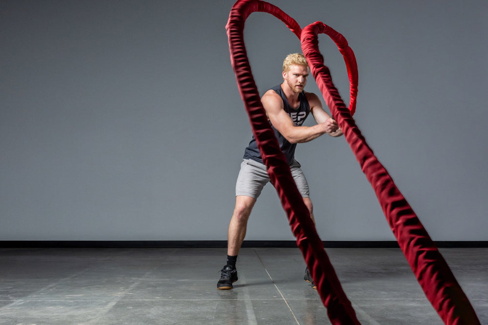 Exercising with red Battle Ropes