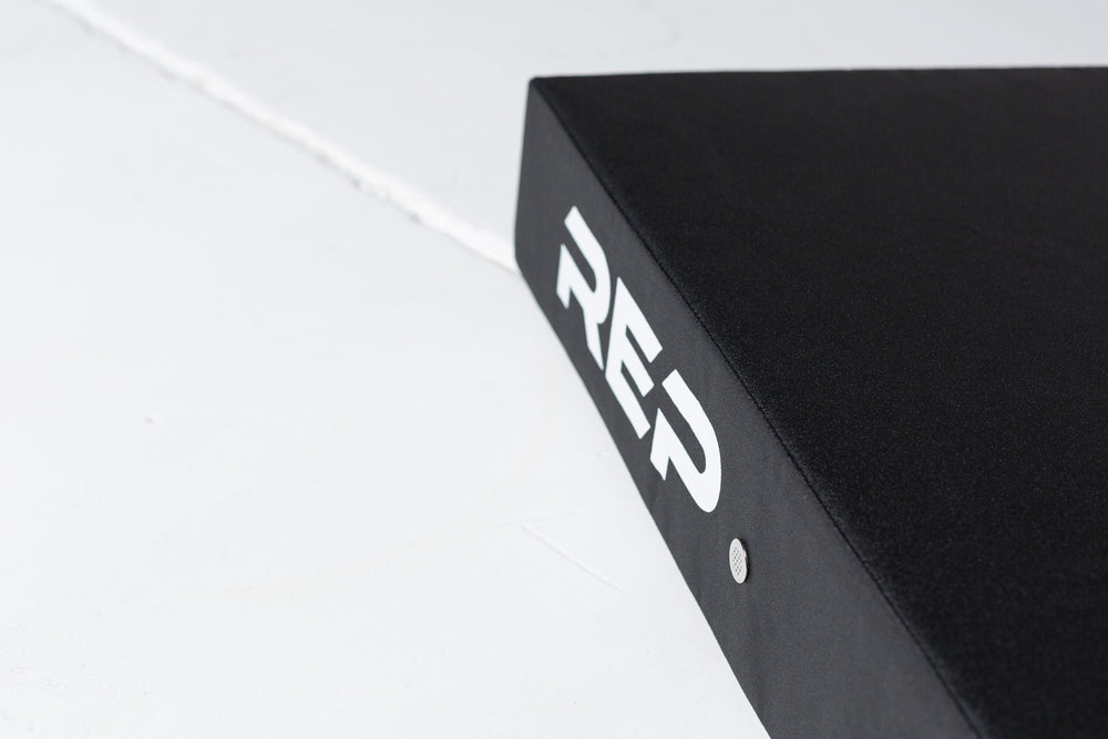 Angled view of the top and side of a REP Crash Pad showing the white "REP' logo and an exhaust vent.