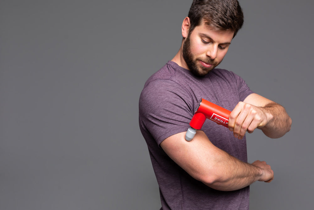 Individual using the Rapidstrike Massage Gun on his tricep.