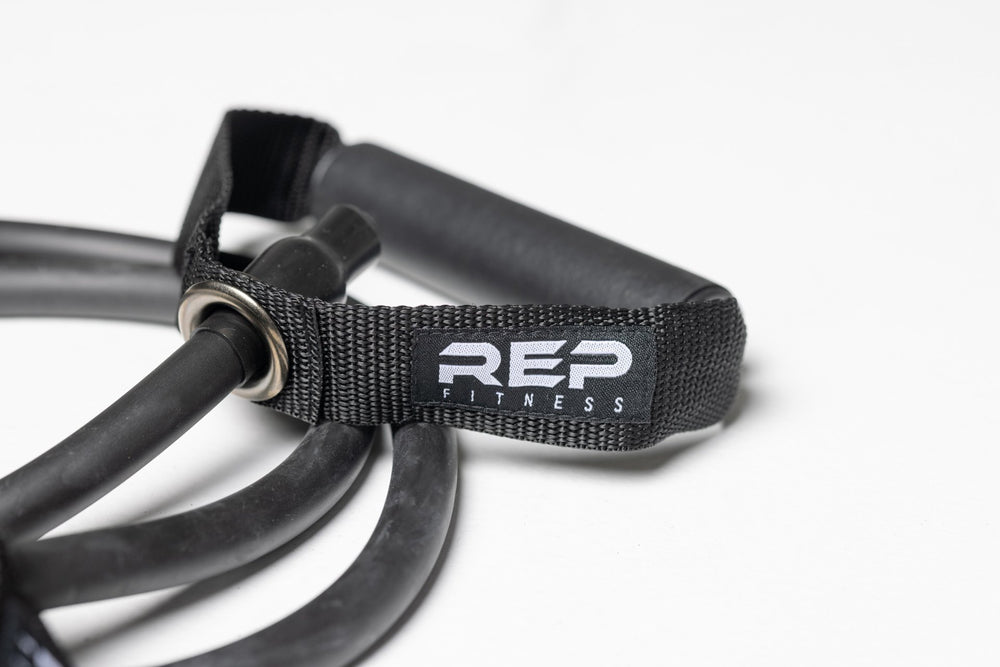 Close-up view of the black heavy resistance band and one of its handles.