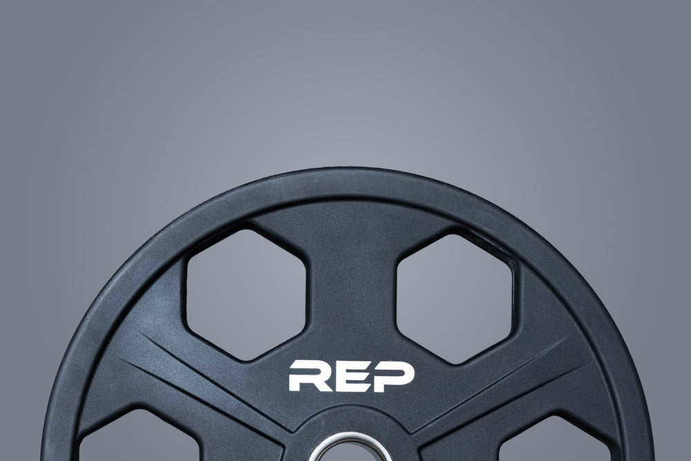 Close up view of the top half of a 45lb Urethane Coated Equalizer Plate with the white "REP" logo.