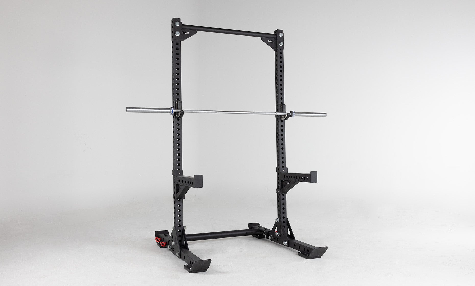 Oxylus Yoke UHMW Liners on Oxylus Yoke With Pull-Up Bar, Spotter Arms, and J-Cups Holding a Barbell